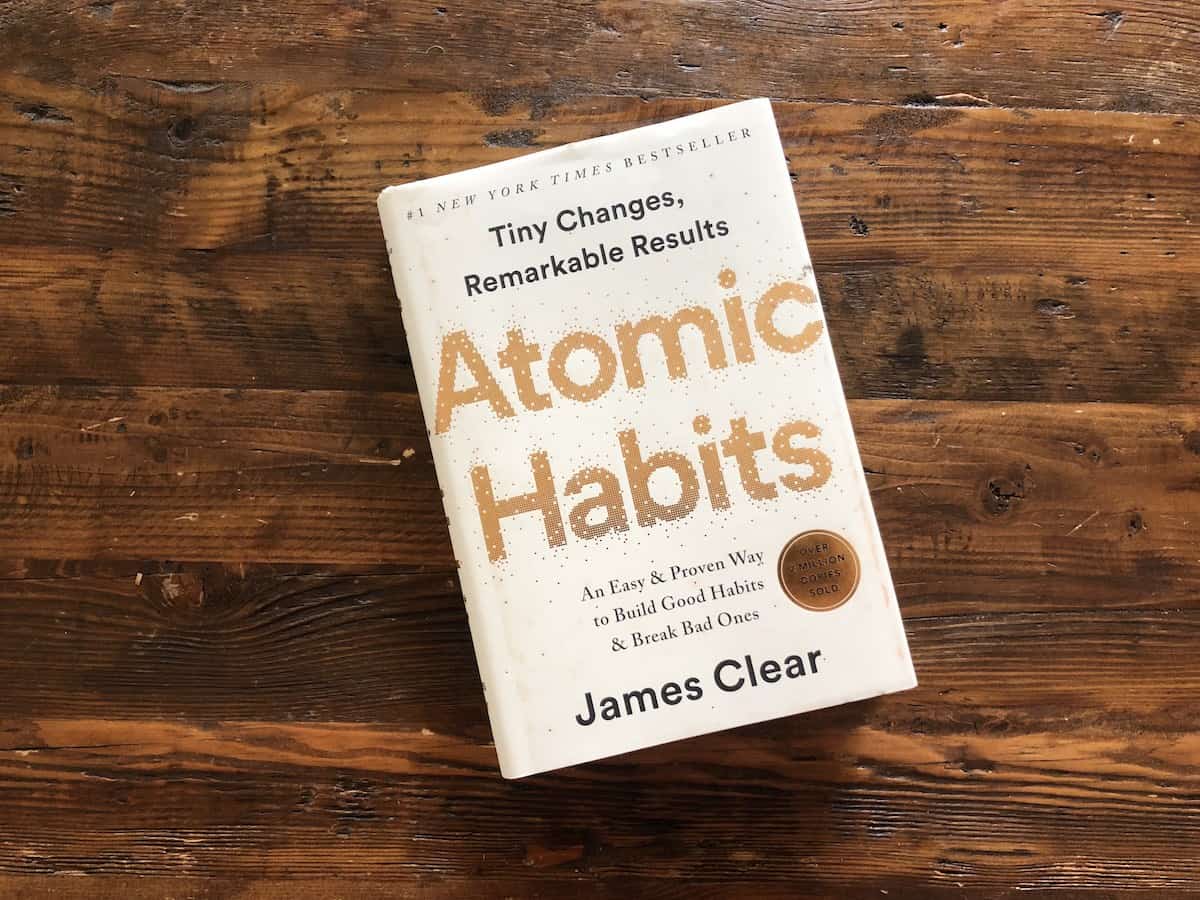Atomic Habits by James Clear sitting on coffee table